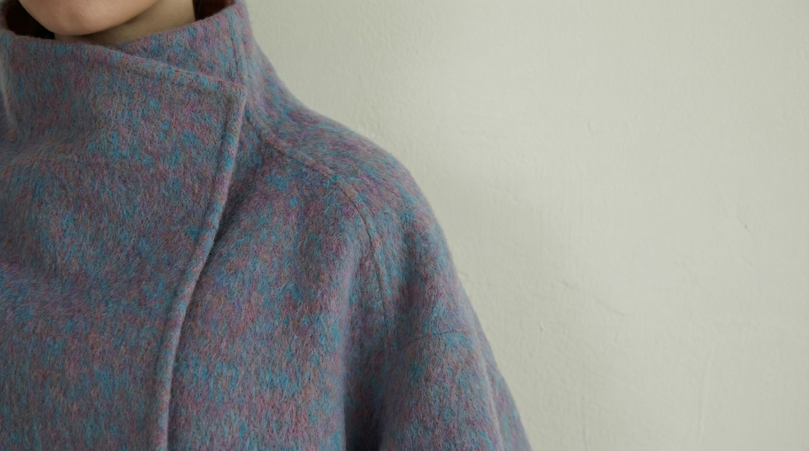 Hand-finished wool coats by CocoonCash featuring refined craftsmanship, structured silhouettes, and Eastern cultural aesthetics.